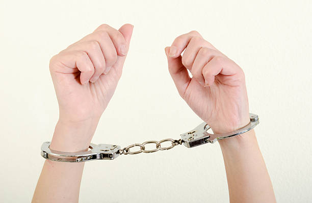 istock Hands of a woman with handcuffs 537358868