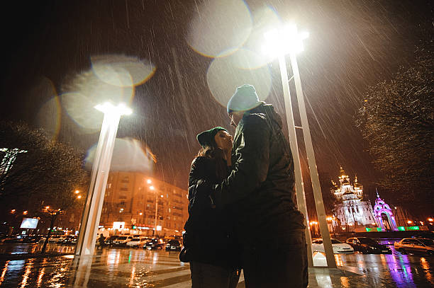 istock Couple walking through town together at night 537359618