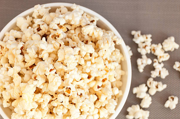 istock popcorn in a white bowl on a gray background 537361784
