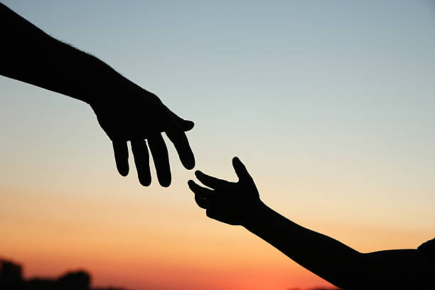 istock silhouette parent and child hands 537362098