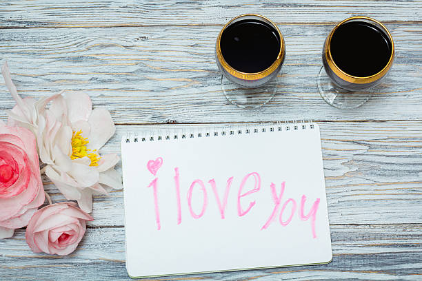 istock two glasses of red wine and flowers 537363264