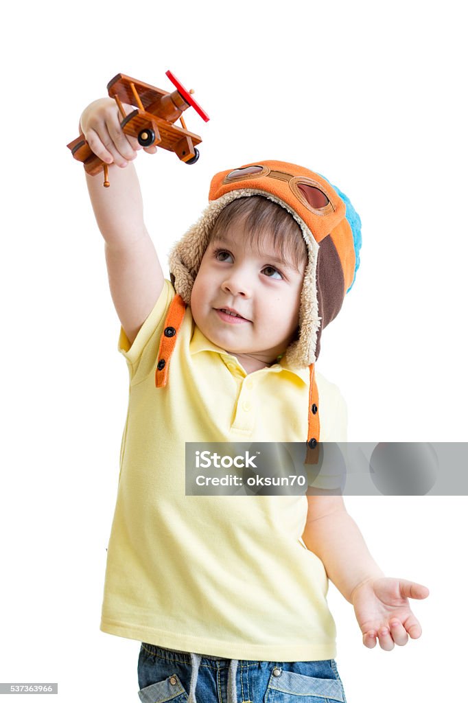 happy kid boy pilot and playing with wooden airplane toy happy kid boy dressed pilot and playing with wooden airplane toy Activity Stock Photo