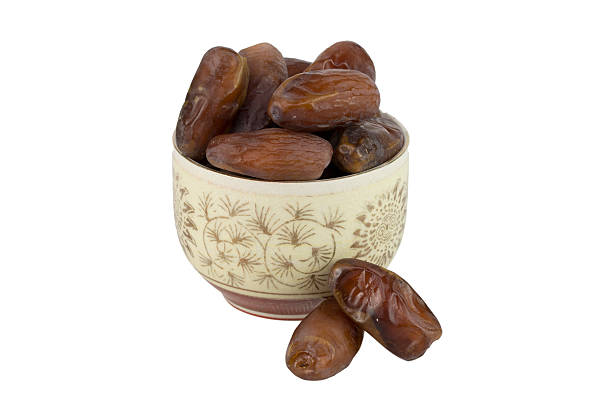 istock dried dates in the bowl on white background 537365286
