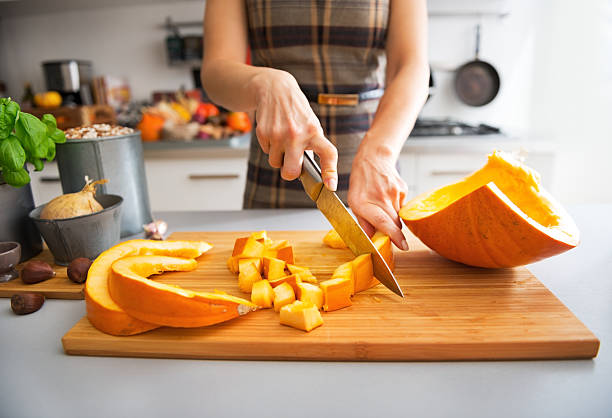 istock closeup on young housewife cutting pumpkin 537366069