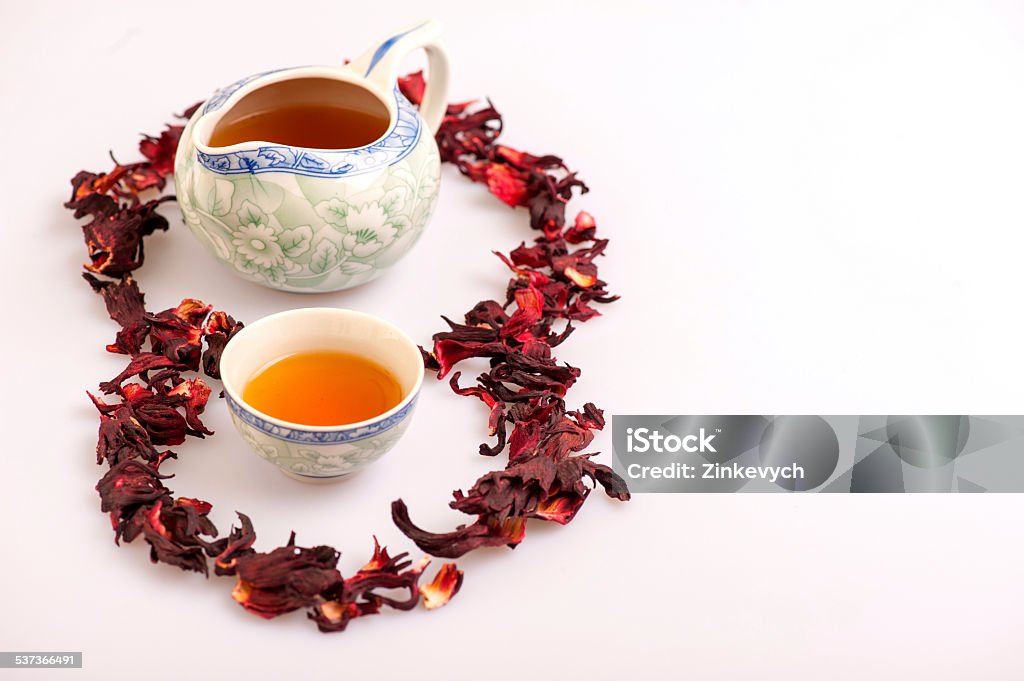 Tea ceremony still life isolated on white This brew smells lovely. Image of teapot and a cup of tea surrounded by flower tea composition isolated on white background 2015 Stock Photo