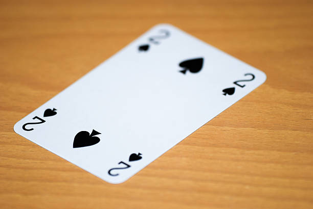 A poker hand of cards showing a spade flush. On a white background.The cards are reproductions of antique cards.