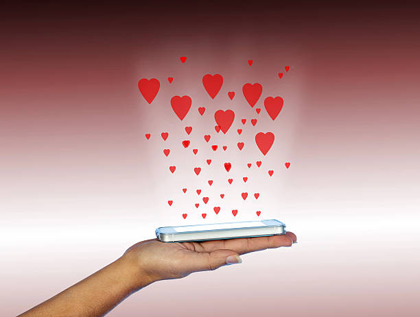 istock Mobile phone in woman hand. With many red hearts. 537367857