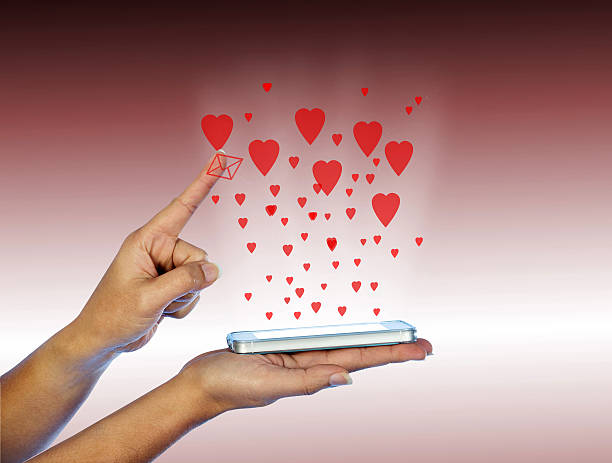 istock Mobile phone in woman hand. With many red hearts. 537367861