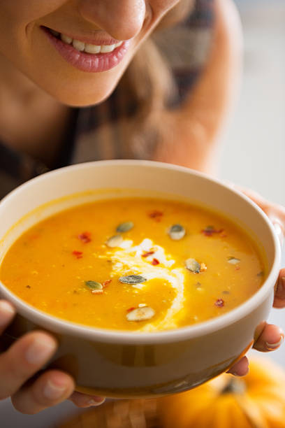 istock closeup on young woman enjoying pumpkin soup 537368023