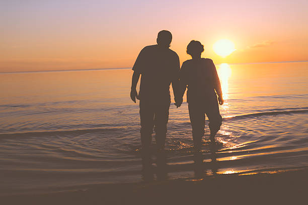 istock Senior couple walking at sunset 537368109
