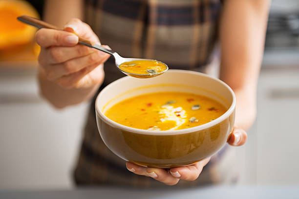 istock young woman showing pumpkin soup 537368233