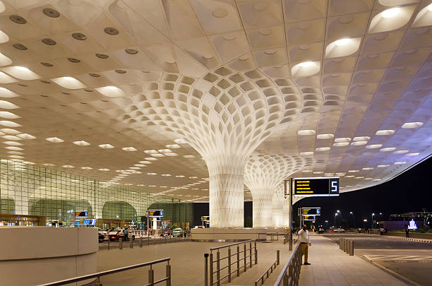 Travelers visit Chhatrapati Shivaji International Airport. Mumbai, India - January 5, 2015: Travelers visit Chhatrapati Shivaji International Airport. The New Terminal 2, International Departures on January 5, 2015 in Mumbai, India. Skidmore, Owings and Merrill (SOM) was the architectural designer of the project. india airport stock pictures, royalty-free photos & images