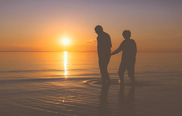 istock Senior couple walking at sunset 537369387