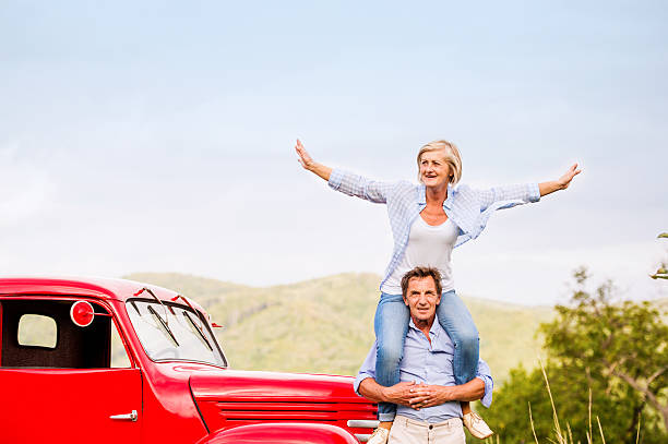 istock Senior couple standing at the red vintage car 537370184