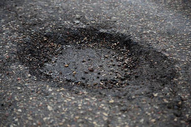 istock The pit on the asphalt road with puddle 537370667