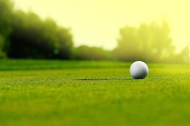 In the hole Close up of a golf ball close to the hole golf ball photos stock pictures, royalty-free photos & images