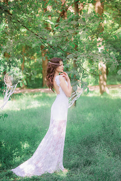 Beautiful girl with long curly hair in a white dress stock photo