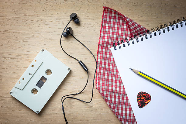 istock Cassette ,headphones and blank notebook on wood for songwriter 537379364