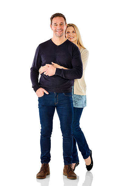 istock Affectionate middle aged couple standing together over white 537379482