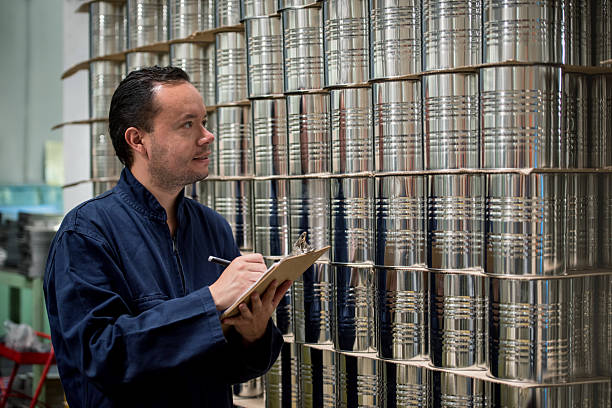 Man working at a metal factory and doing inventory