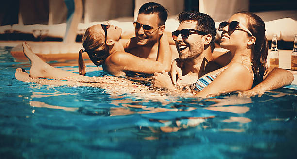 istock People enjoying drinks by the swimming pool. 537382554