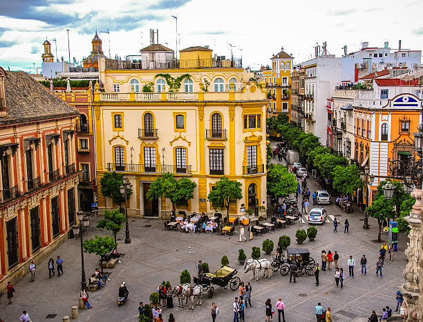 Plaza Del Triunfo in Seville, Spain Plaza Del Triunfo in Seville, Spain with rooftops and the Santa Cruz church in the distance. Taken from the "La Giralda" bell tower in the Cathedral of Seville. seville stock pictures, royalty-free photos & images