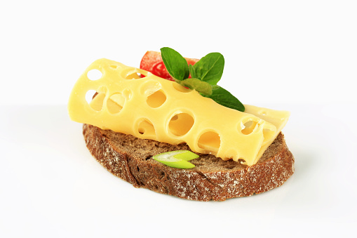 Slice of brown bread with Swiss cheese