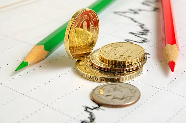 Finance graph coins and colored pencils.