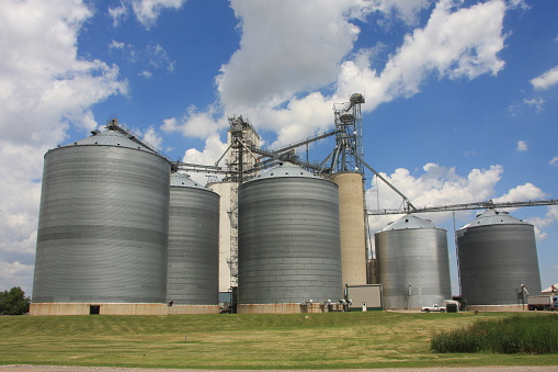 This grain bin complex stands out against a beautiful Iowa sky on a warm summer day. 