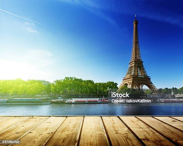 Background With Wooden Deck Table And Eiffel Tower In Paris Stock Photo - Download Image Now