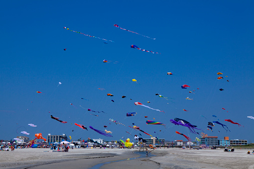 Variety of colorful Kites in a clear blue sky at the annual Wildwood International Kite Festival held on the beach each year over Memorial Day weekend in May in New Jersey.
