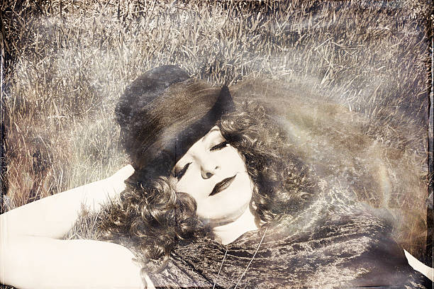 istock Woman in grass wearing top hat 537385321