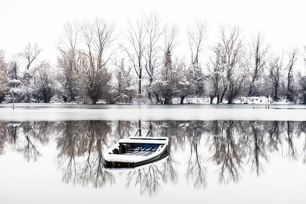 abandoned boat in a frozen lake winter in Novi Sad Serbia