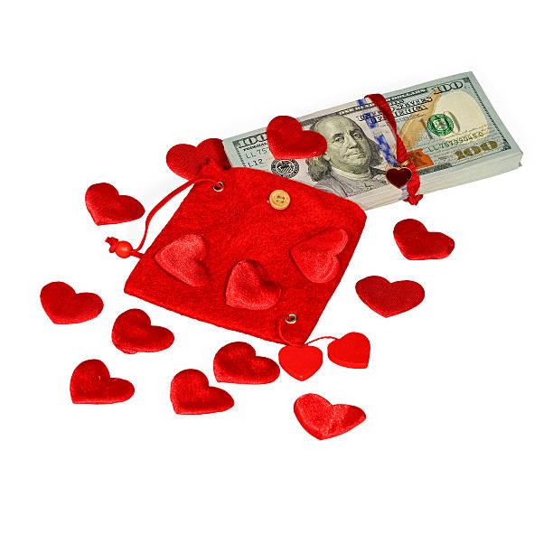 istock Bundle of dollars in red pouch with hearts 537386019