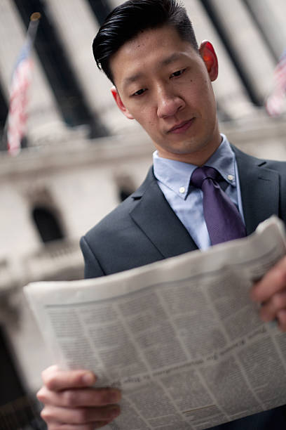 Asian Man in Financial District in New York City Asian Man in Financial District in New York City. newpapers stock pictures, royalty-free photos & images