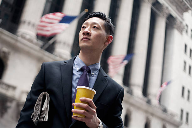 Asian Man in Financial District in New York City Asian Man in Financial District in New York City. newpapers stock pictures, royalty-free photos & images