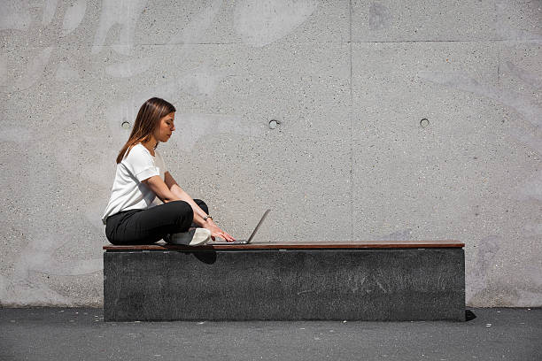 istock girl, laptop, concrete 537386498