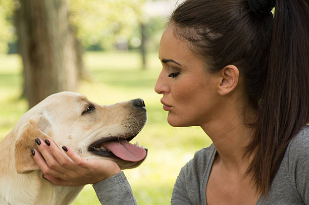 istock yong woman posing with her dog 537387284