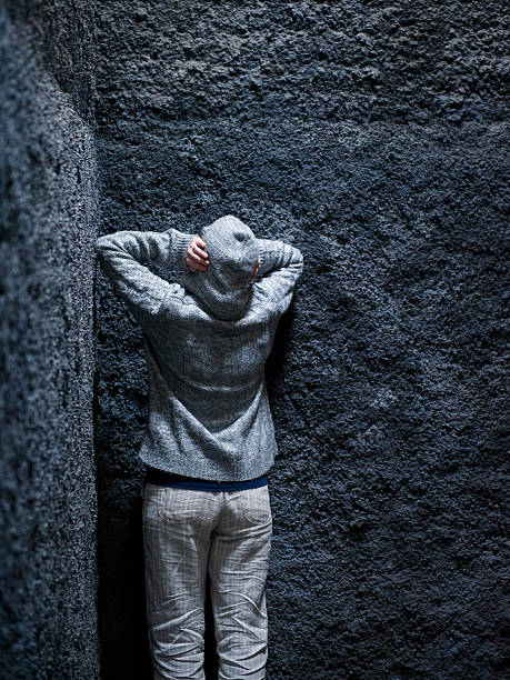 istock Scared, insane woman hiding in a corner 537387328