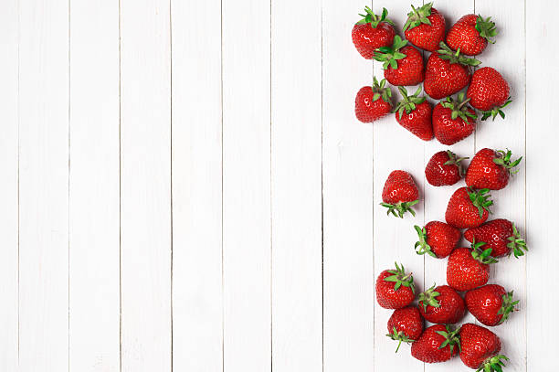 istock Strawberries on white wood 537388116