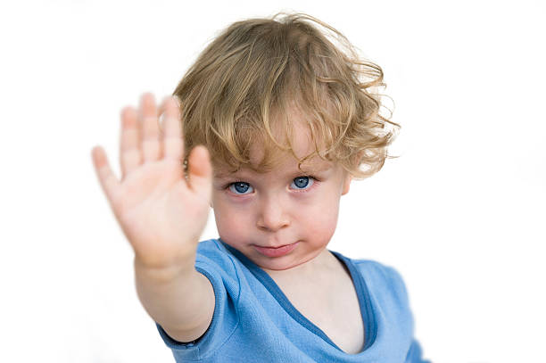 Child saying no Child saying no. Toddler lifting hand in protest isolated on white background. stop single word stock pictures, royalty-free photos & images