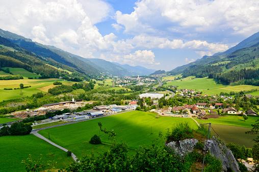 Beautiful valley in the Austrian Alps with little town, meadows and hills