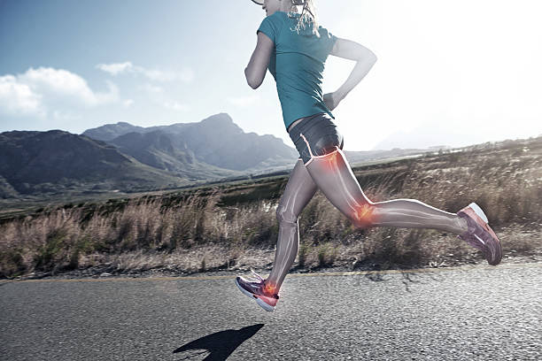 Running is quality time with me Cropped shot of a young woman out on a country road for a jog human knee stock pictures, royalty-free photos & images