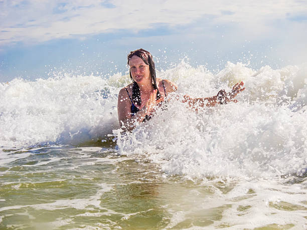 istock woman bathes in the surf 537389205