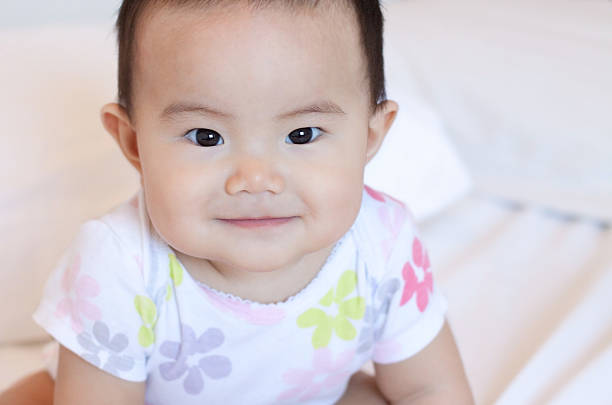 istock Cute Little Girl Sitting On The Bed 537389633