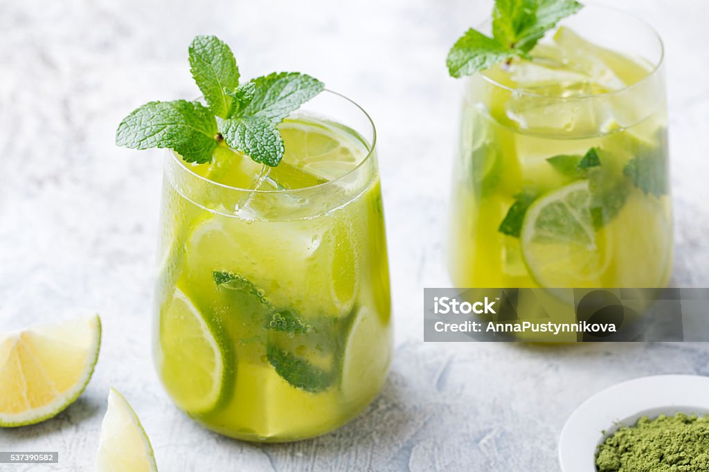 Matcha iced green tea with lime and fresh mint Matcha iced green tea with lime and fresh mint on a marble background Mint Leaf - Culinary Stock Photo