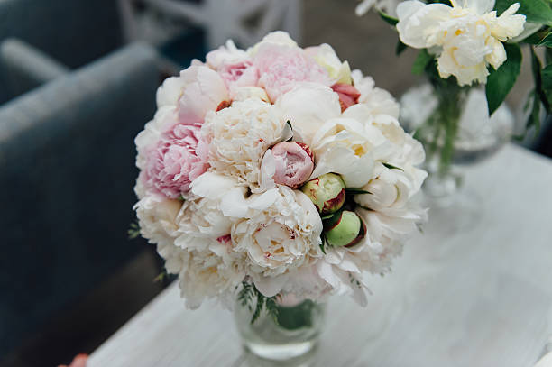 flowers of colored peonies flowers of colored peonies on a wooden table peone stock pictures, royalty-free photos & images