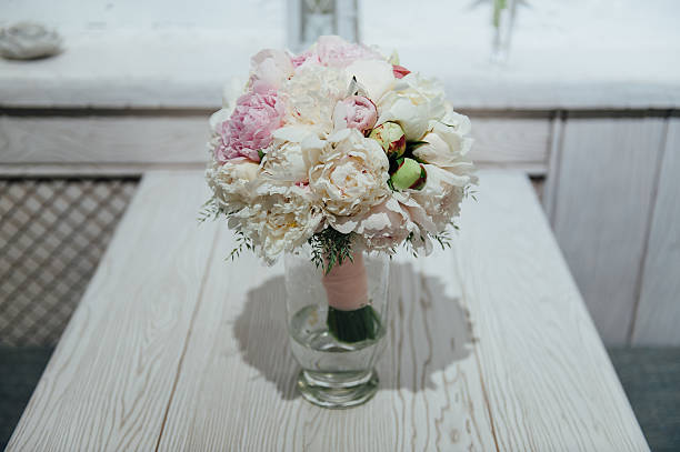 flowers of colored peonies flowers of colored peonies on a wooden table peone stock pictures, royalty-free photos & images