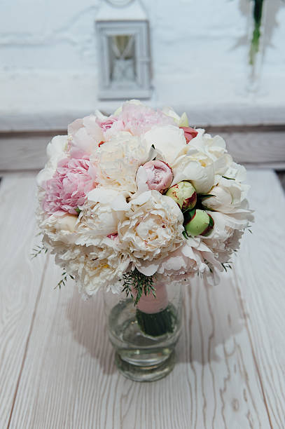 flowers of colored peonies flowers of colored peonies on a wooden table peone stock pictures, royalty-free photos & images