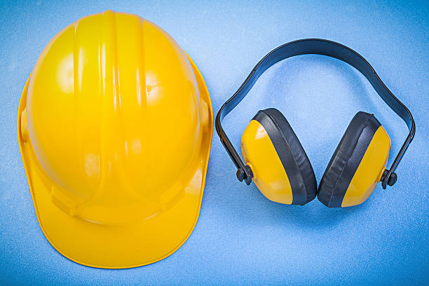 istock Safety earmuffs hard hat on blue background construction concept 537392428